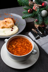 Christmas lunch with a plate of onion soup on the table close-up