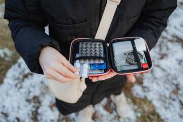 A compact yet essential medical kit complete with necessary medications and supplies designed for winter outdoor activities and emergencies