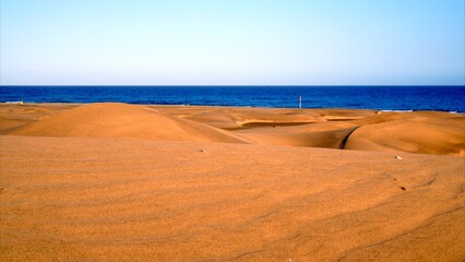 Textures and curves on the golden sand desert with dunes to Maspalomas beach in the Canary Islands © Canary4stock