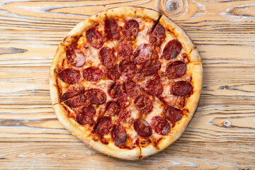 Pizza pepperoni fast food . Top view on rustic background
