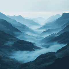 blue dawn mist rolls through mountain valleys creating layers of shadows and highlights in a silent world