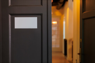 A close-up view of an open door with blank panel