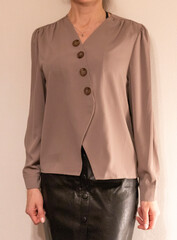 Skinny woman wearing stylish leather tight skirt and warm tone blouse. Fashion