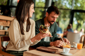Enjoying a delightful brunch together at a cozy cafe on a sunny afternoon in the heart of the city