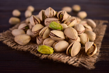 Pistachio nuts on a dark background. Close-up.