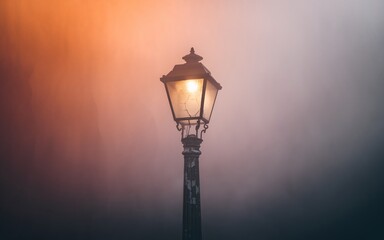 street lamp in the fog A lone street lamp glows brightly through the fog at dusk.