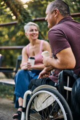 Couple Talking And Drinking Coffee In Park