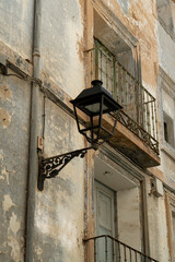 Vintage Street Lamp on Weathered Building Facade