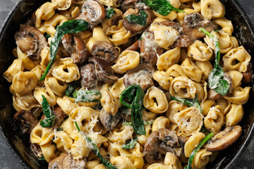 Chestnut Mushrooms and spinach tortellini served with parmesan cheese