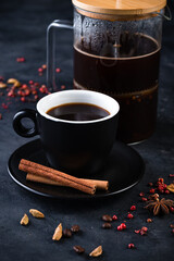 coffee with anise, cinnamon and cardamom on a dark background