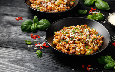 Homemade Taco Beef Pasta in a black bowl. Mexican food.