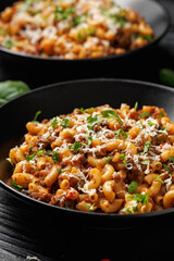 Homemade Taco Beef Pasta in a black bowl. Mexican food.
