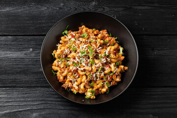 Homemade Taco Beef Pasta in a black bowl. Mexican food.