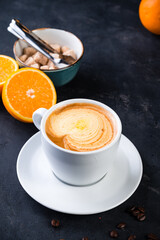 cappuccino coffee with orange juice in a cup