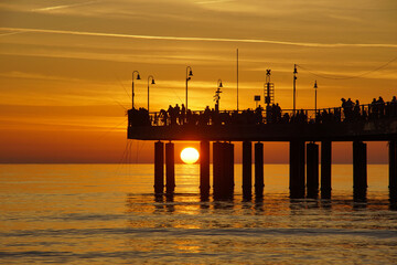 sunset with a pier in marina di pietrasanta