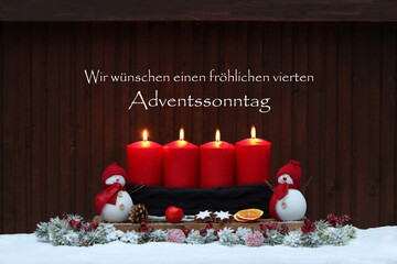 Vierter Advent: Adventsdekoration mit vier roten Adventskerzen, Schneemann, Weihnachtsschmuck im...