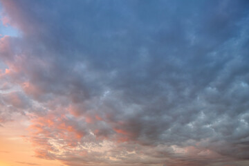 Summer evening sky in the picturesque clouds, lit by the rays of the setting sun.