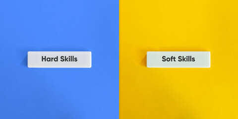 Hard Skills versus Soft Skills. Text on Block Letter Tiles on Yellow and Blue Background. Minimal...