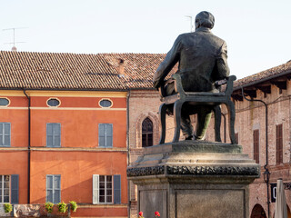 Rear view of Giuseppe Verdi bronze statue sitting on a chair in in main square of Busseto, Parma, Italy - Powered by Adobe