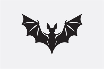 A black silhouette of a flying bat with outstretched wings.