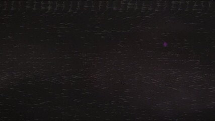 Dark grainy film texture with subtle static and light specks