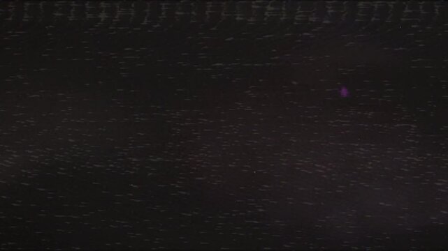 Dark grainy film texture with subtle static and light specks