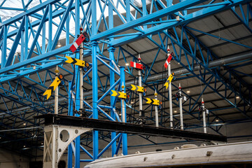 A group of old UK semaphore railway signals on a gantry