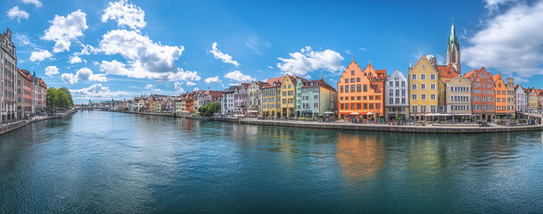 Panoramic view of the beautiful cityscape with colorful buildings and church spires reflecting in the river
