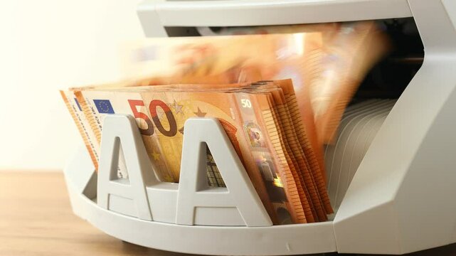 Euro money. Counting euro banknotes with a money converting machine. Financial concept. Currency exchange, bank calculations, business settlements