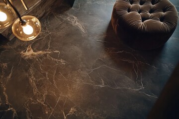 A dark brown stone floor with matte finish, featuring a plush velvet ottoman and designer lighting.