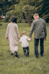 family, togetherness, outdoors, nature, parenthood, love, bonding, happiness, childhood, green, trees, grass, casual, relaxation, parenting, embrace, peaceful, moment, memories,