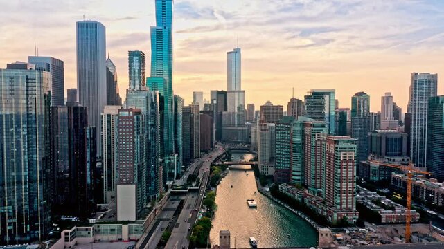 Revealing shot of Chicago, Illinois skyline at sunset with slow camera pullback along Chicago River. Chicago is the most populous city in the U.S. state of Illinois and in the Midwestern United States