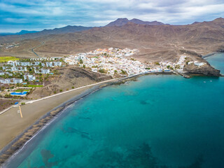 Naklejka premium Aerial drone view of Las Playitas fishing town and the beach, Fuerteventura, Canary Islands