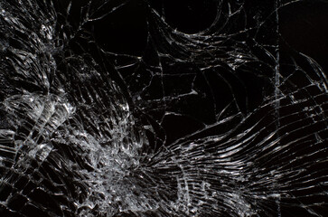 Cracks on the glass of the smartphone on a black screen