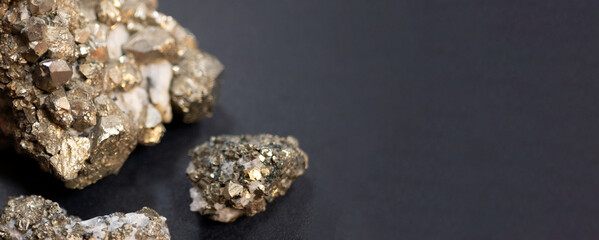 Sparkling pieces of pyrite stone of different sizes, banner. Concept of iron pyrite, abundant sulfide mineral