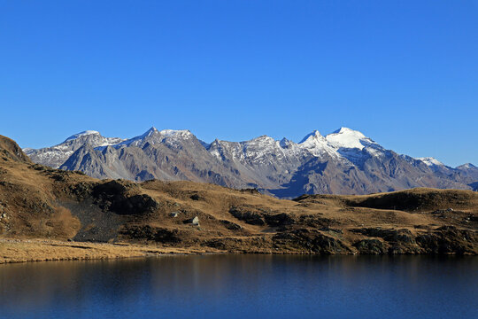 Alpine lake with Adula glacier in the background on a beautiful autumn day