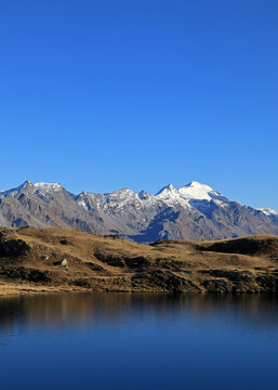 Alpine lake with Adula glacier in the background on a beautiful autumn day
