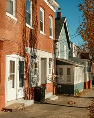 Row of houses with brick and wooden exteriors bathed in afternoon light, Verplanck, New York.