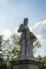 Eger, Hungary May, 18 2024. Statue of Saint Paul in front of the Eger Basilica. The sculpture of Apostle in Cathedral Basilica of St. John the Apostle. Outdoor details of Catholic Church in Europe.