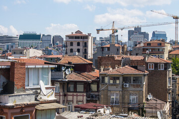 Fototapeta premium ISTANBUL, TURKEY - August 12, 2024: Panoramic view of the tall buildings of the city on a sunny summer day