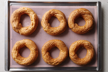 cream puff rings on a baking sheet