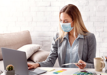 Girl in protective mask, with laptop and color swatch