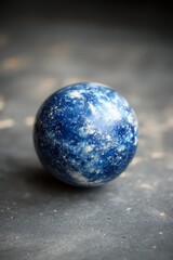 A blue and white marble ball sitting on a table