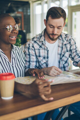 Multiracial couple organizing next travel on map