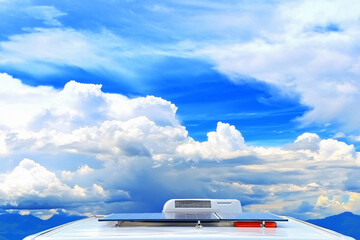 solar panels mounted on RV roof against dramatic storm clouds, lifestyle perspective