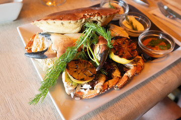 Whole crab served with tasty sauce dips, lemon and dill.