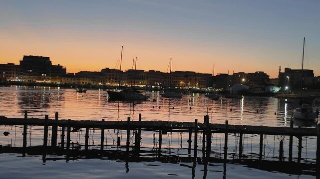 Magical sunset in the port of Anzio in Italy. Reflections in the water and vivid colors illuminate the scene with the boats moving. Located on the Tyrrhenian Sea dedicated to Sea dedicated to tourism
