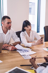 Ambitious multiethnic coworkers browsing devises on business conference