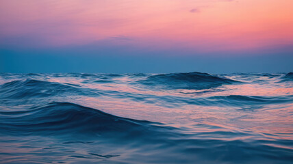 Obraz premium A serene twilight ocean scene with gentle waves, featuring a tranquil color palette of deep blues and soft pinks, creating a calming atmosphere.