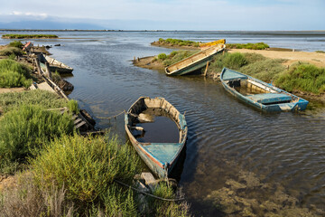 Old fishing boats stranded on the shore of the Delta del Ebro